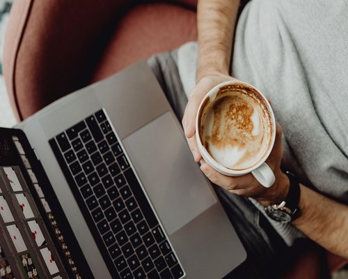 man over 40 working on a laptop at home in Indonesia